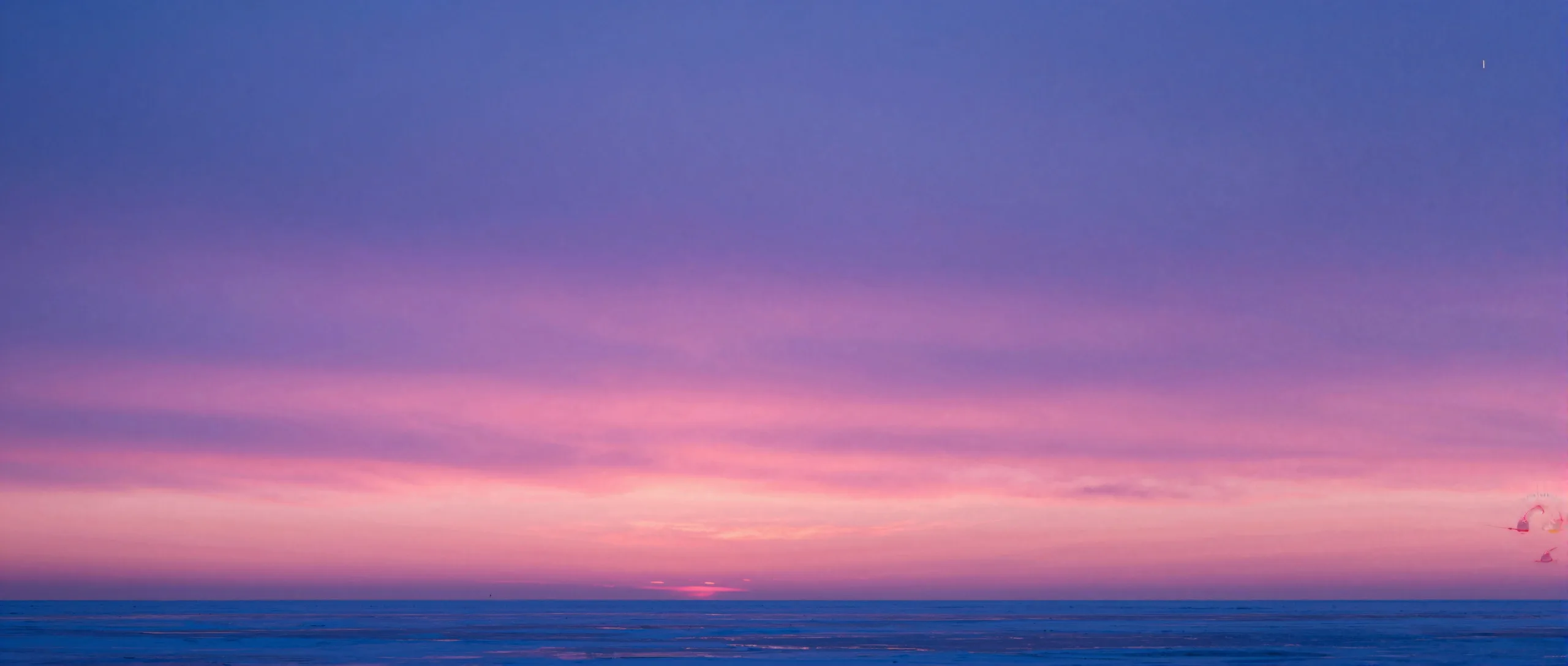 Magenta and electric-blue twilight horizon glowing across layered ice