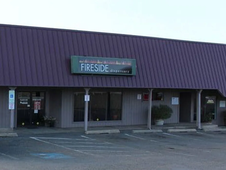 Fireside Dispensary storefront in Oregon, shopping-plaza exterior with the Fireside Dispensary signboard above the entrance.