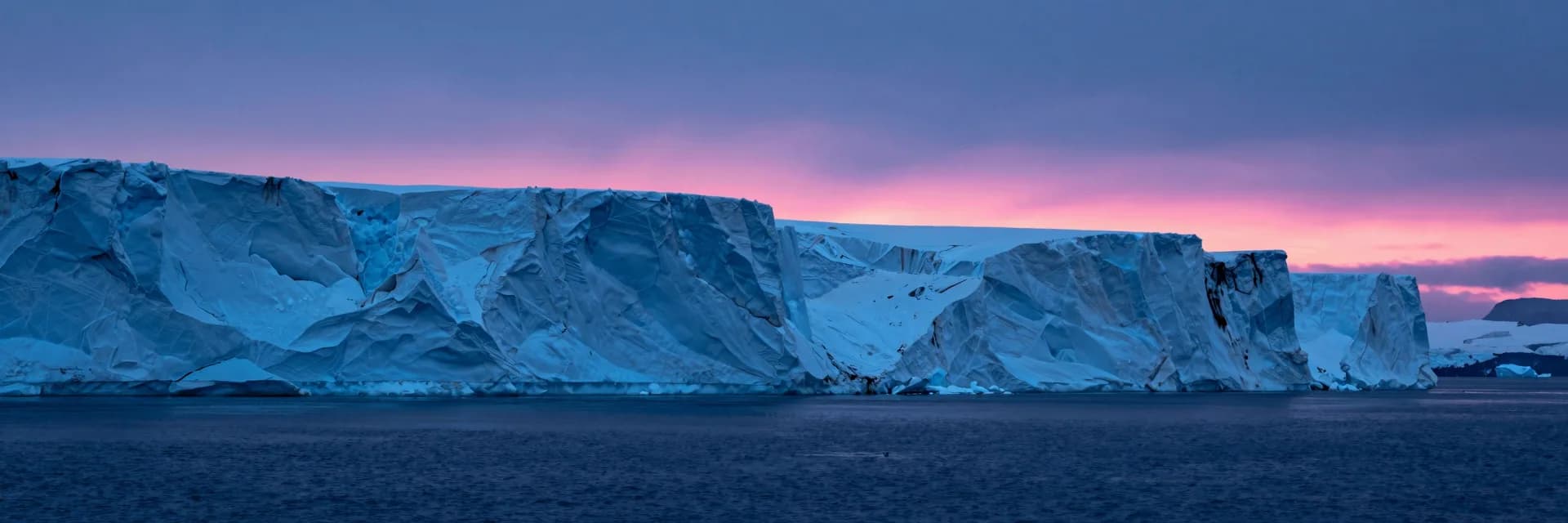 ultra-wide strip of electric-blue ice cliff strata with hot-pink sunset accent - companion image for the small-traffic DTC A/B testing essay