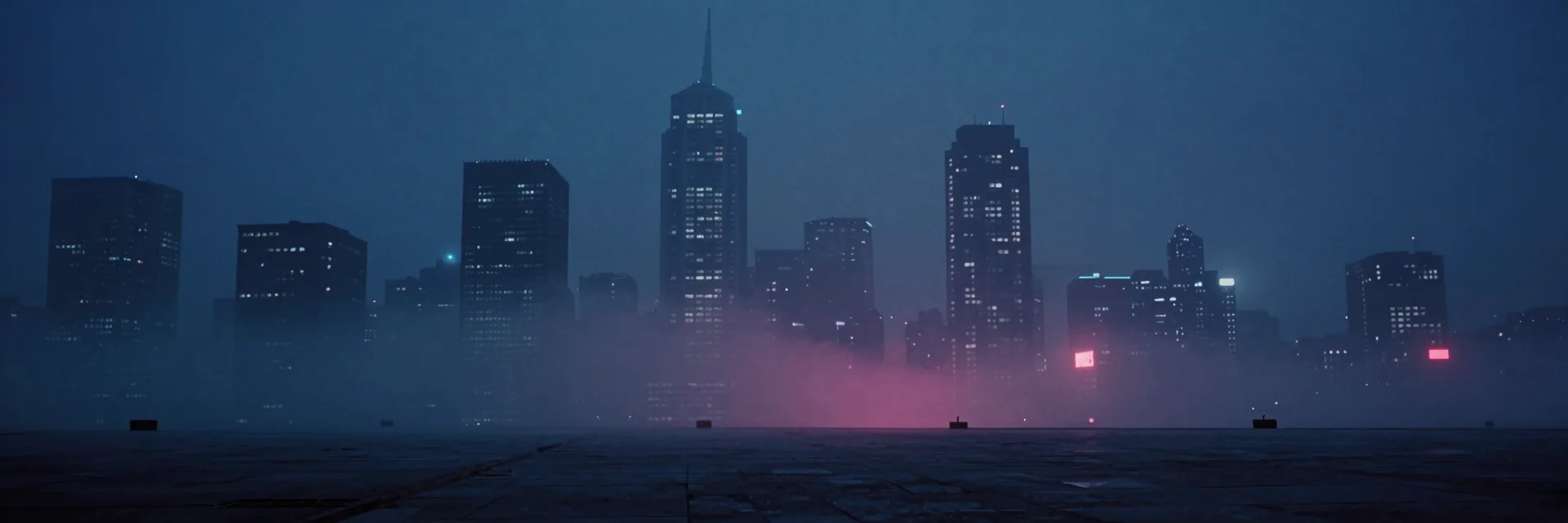 The full city panorama of layered towers fading into deep fog, a scatter of lit windows and faint signage marking depth across the empty skyline.