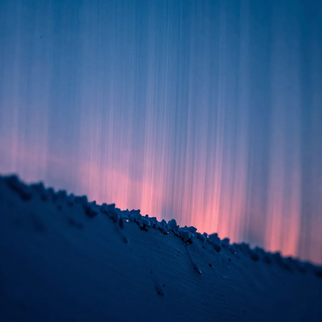 Macro detail of polished glass surface with cool electric blue rim light and subtle pink reflection at the edge.
