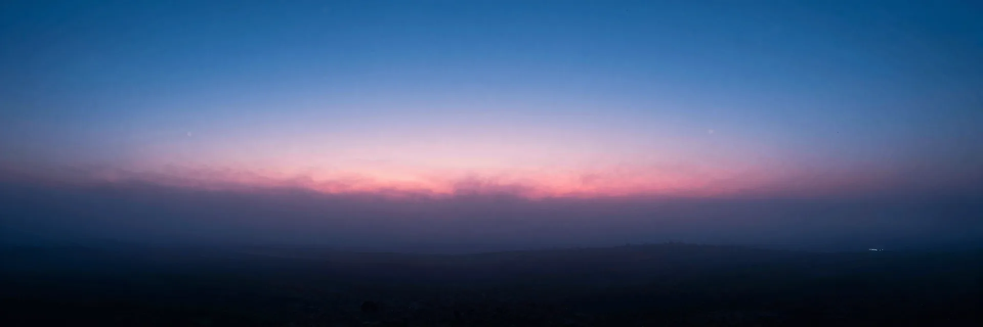 Pure dusk fog rolls across an empty horizon with no pillars in frame, soft layers of atmosphere stretching into low light.
