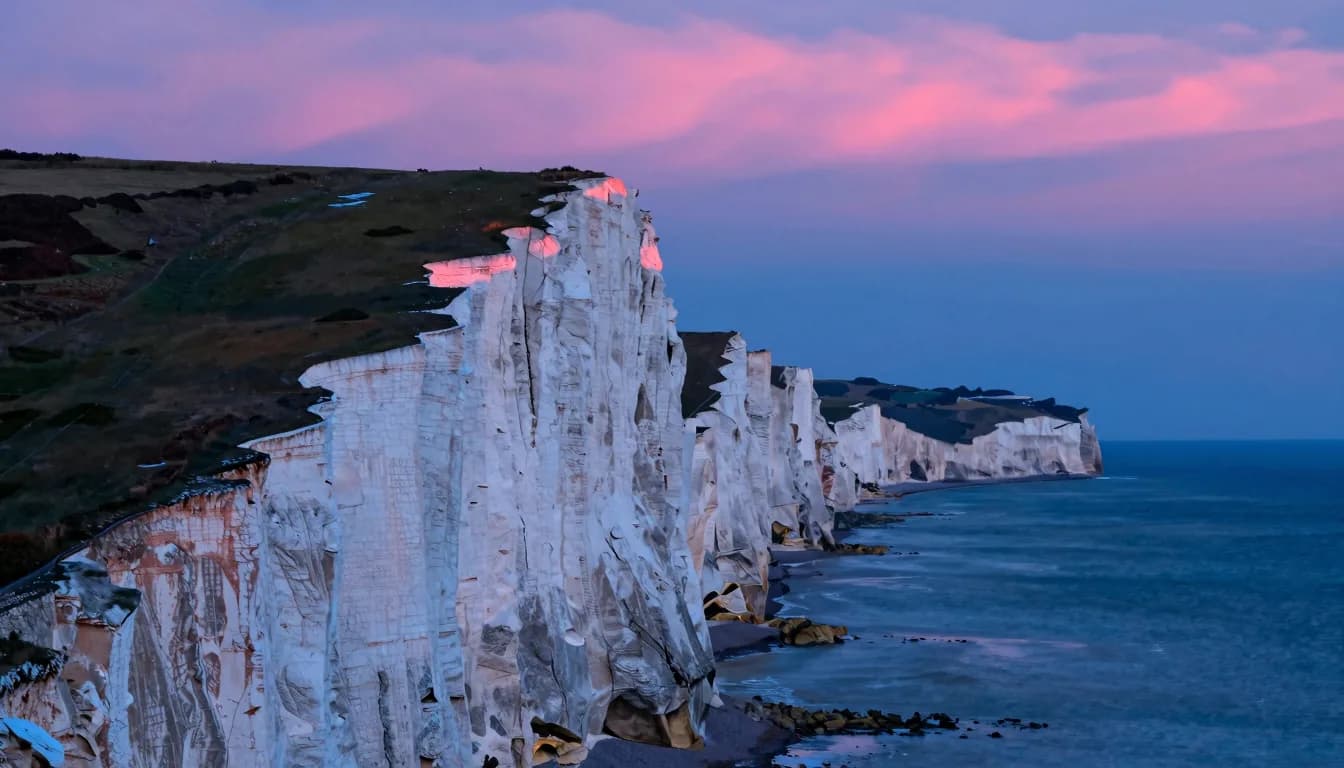 Vertical-emphasis composition of a single tall white chalk cliff dominating the frame