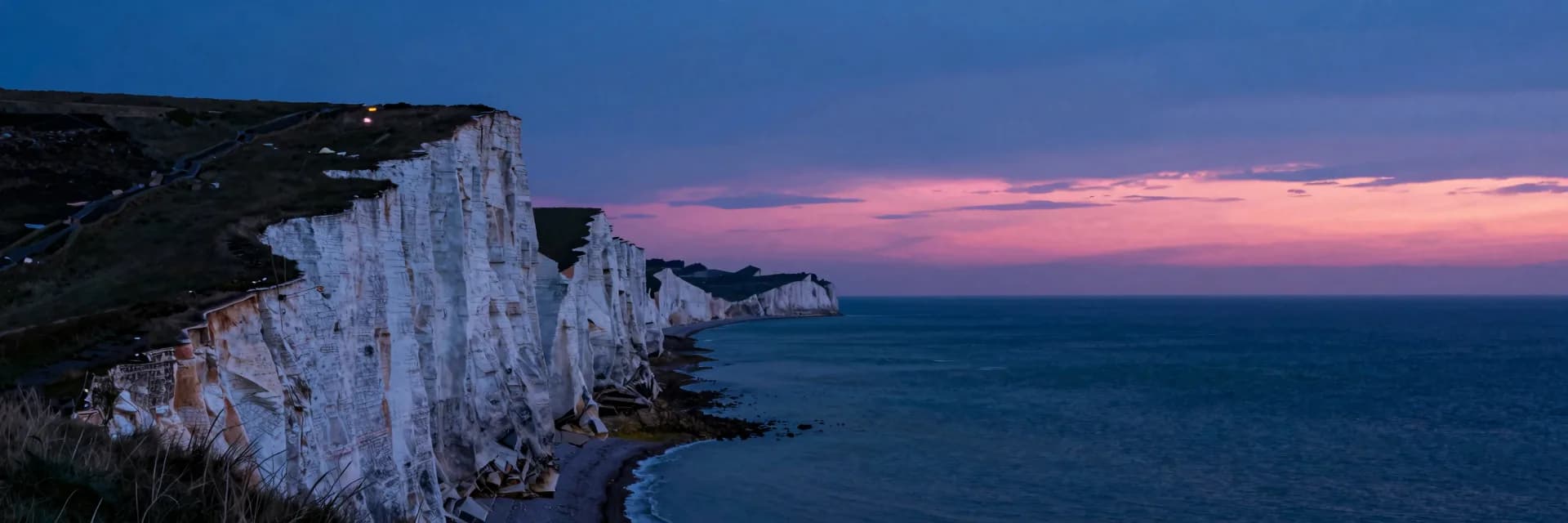 Ultra-wide coastline of white chalk cliffs receding into a vanishing point
