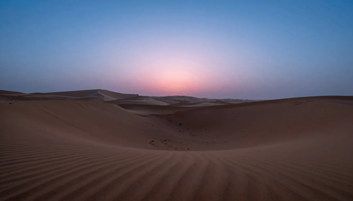 Low oblique view of a sand ring leading across the desert toward distant dunes at dusk