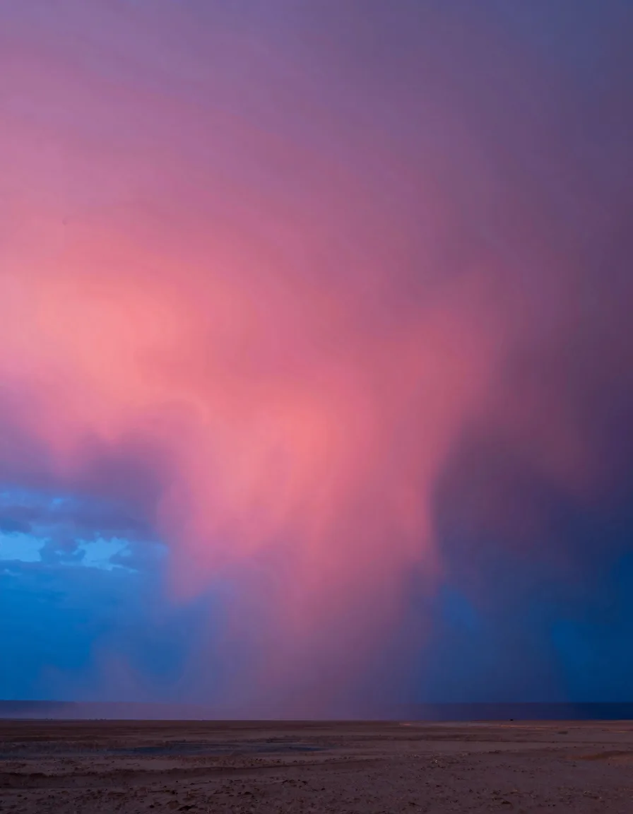 portrait orientation of electric-blue atmospheric scene with hot-pink sunset accent - companion image for the fractional is not a cheaper full-time hire essay