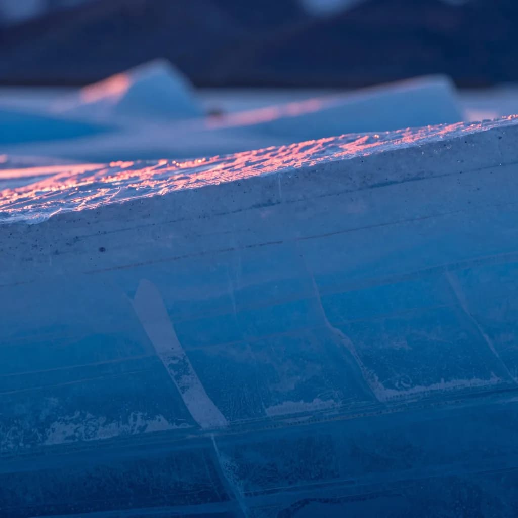 Close-up macro of a single etched glyph in a translucent panel, sharp incision lines catching cool blue light.
