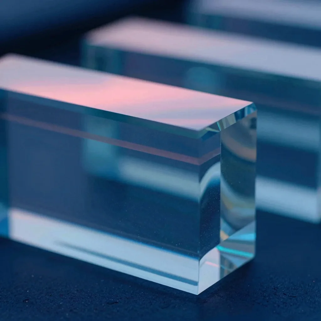 Macro detail of polished glass surface with cool electric blue rim light and subtle pink reflection at the edge.