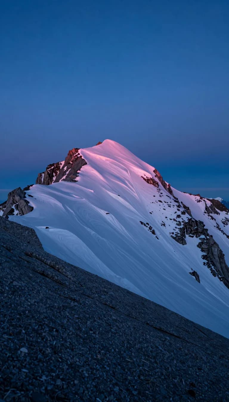 tall vertical of alpine ridge form under electric-blue sky with hot-pink sunset accent - companion image for the Meta attribution audit 31-percent essay