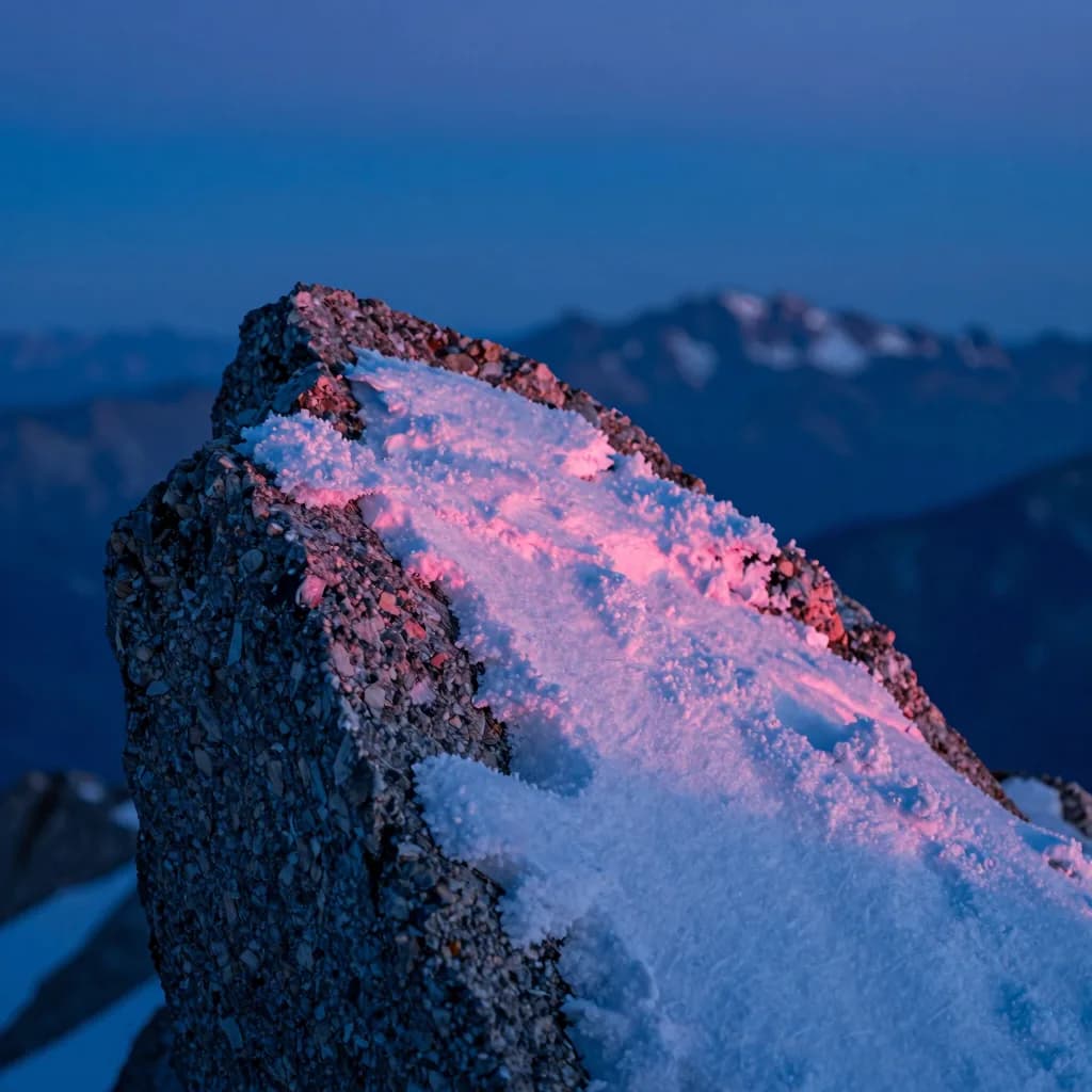 macro detail of alpine ridge form under electric-blue sky with hot-pink sunset accent - companion image for the Meta attribution audit 31-percent essay