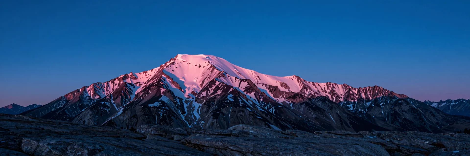 ultra-wide strip of alpine ridge form under electric-blue sky with hot-pink sunset accent - hero image for the Meta attribution audit 31-percent essay