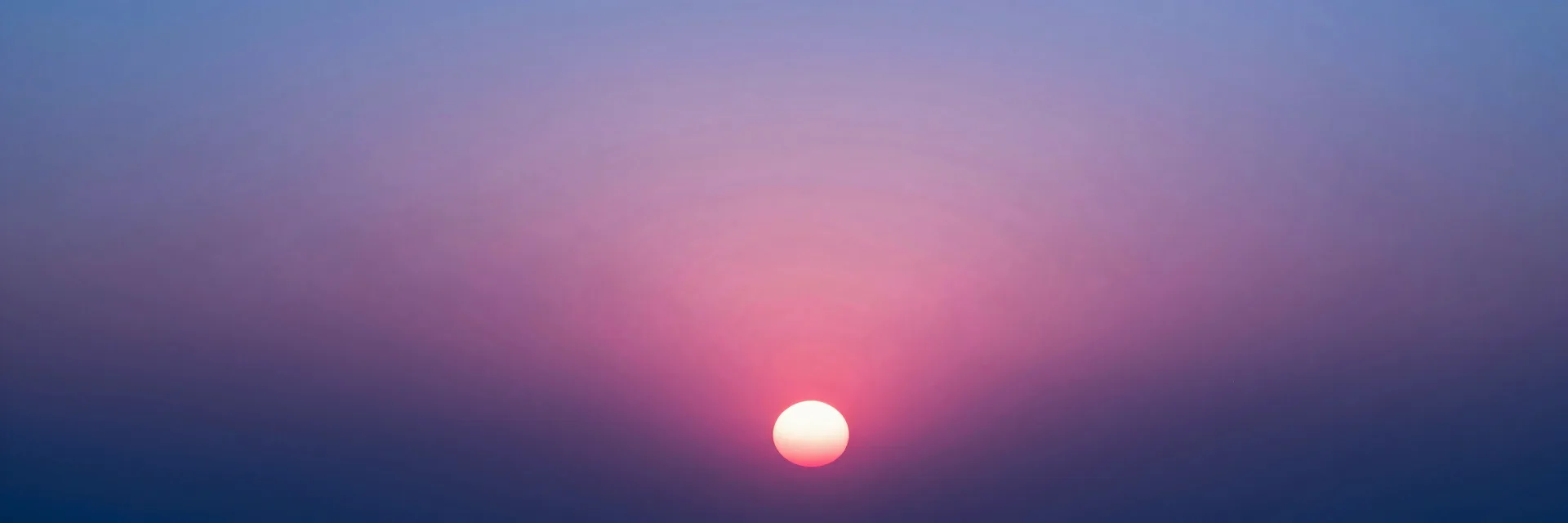 Ultra-wide pure-atmosphere view of the setting sun across an empty horizon, no bridge in frame.
