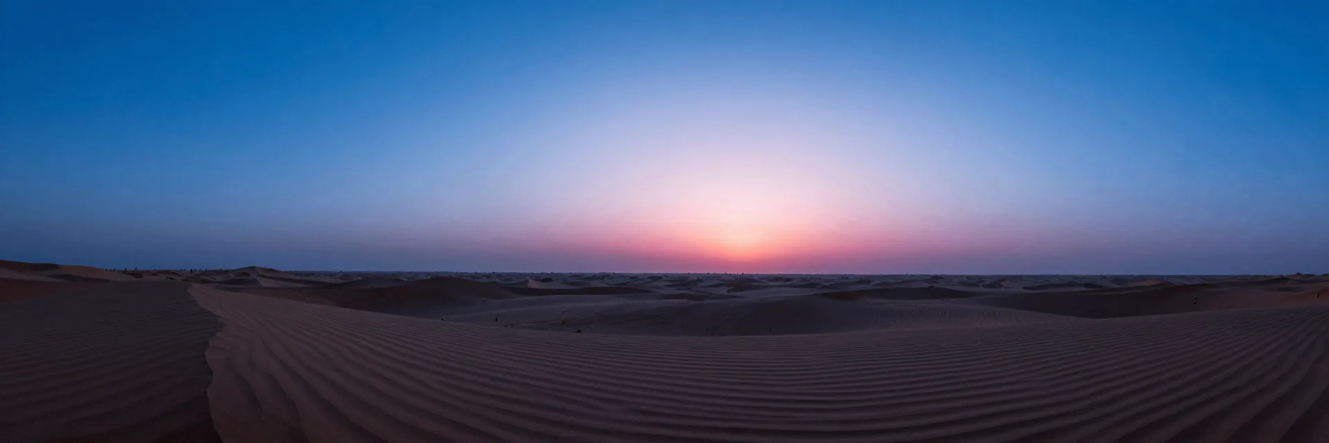 Wide atmospheric scene of layered haze and faint horizon banding under a deep blue sky, mood-driven negative space.
