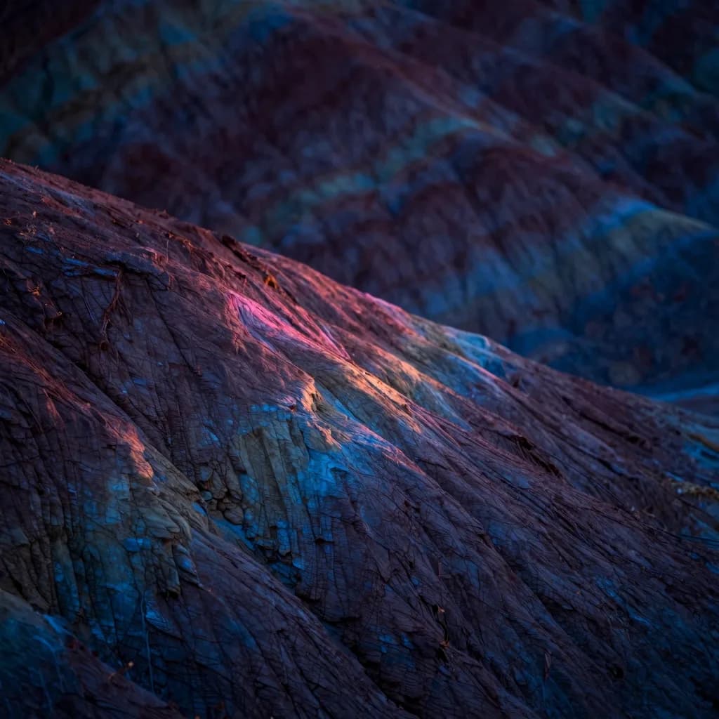 Close-up of the boundary edge where one geological color stripe transitions into the next.