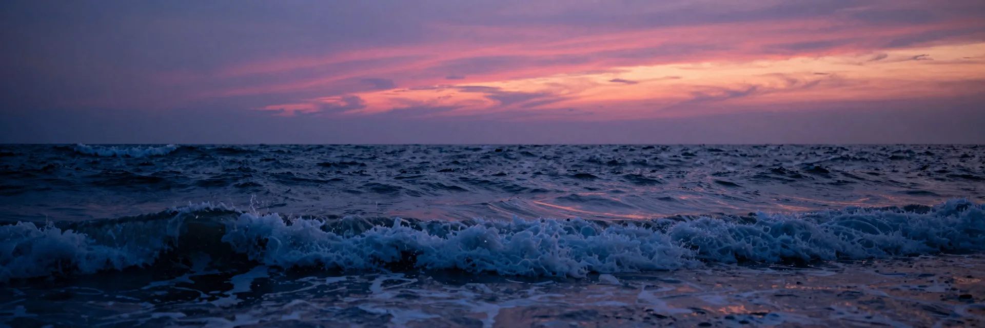 Ultra-wide pure-atmosphere of the open ocean at sunset, white-capped waves stretching across the entire frame, no pillars, dynamic ocean break shot.