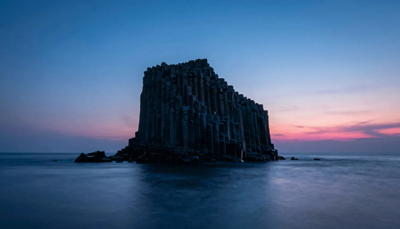 Ultra-wide distant view of a solitary translucent monolith on a dark plain at dusk, vanishing horizon, electric-blue atmospheric haze, single hot-pink rim on the far edge.