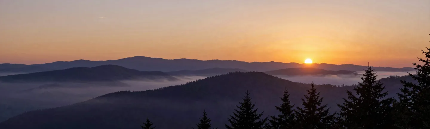 Blue Ridge mountain layers at dawn in panorama.