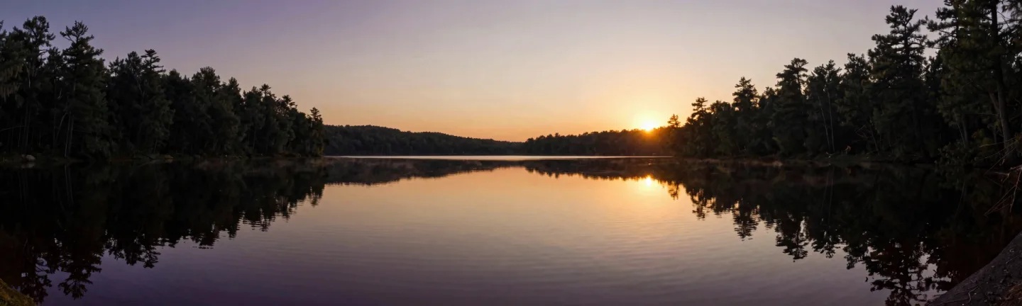 A mirror-still lake at golden hour.